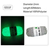 A spool of bright green glow-in-the-dark polyester yarn labeled G011F for knitting and crochet.