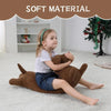 A young girl is sitting on a white rug holding a brown corduroy dachshund body pillow.