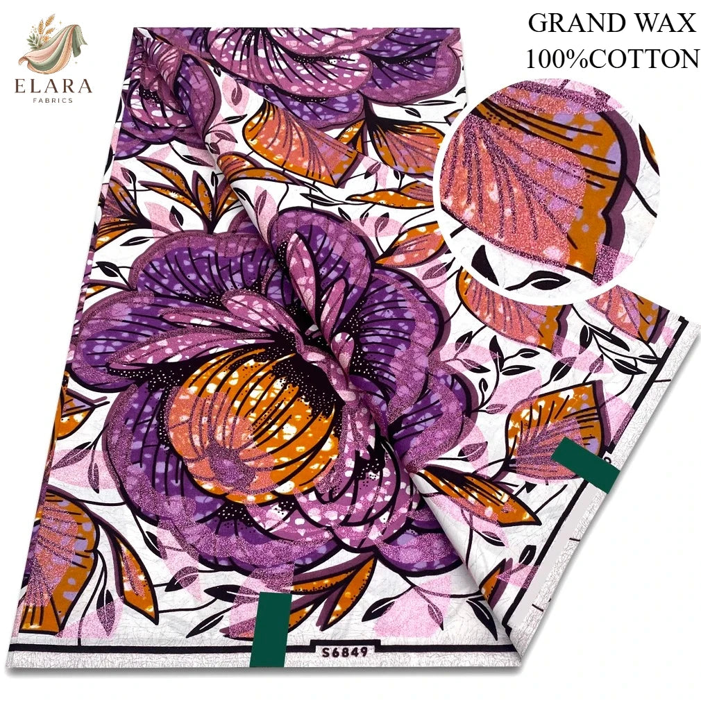 A bolt of purple and orange African wax print fabric with floral patterns.