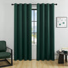 A pair of dark green blackout window curtains hanging on a rod in a bright room.