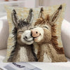 A realistic knitted illustration of two donkeys facing each other on a pillow cover.