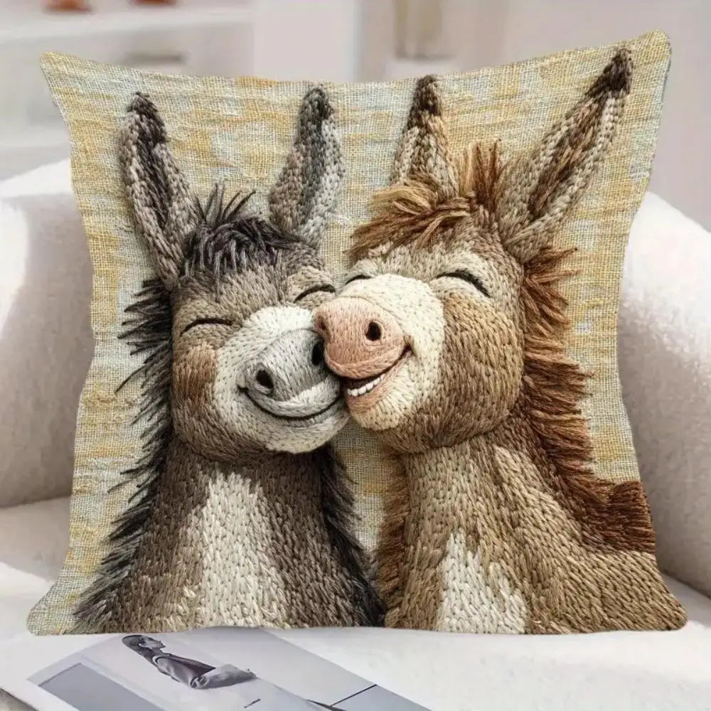 A realistic knitted illustration of two donkeys facing each other on a pillow cover.