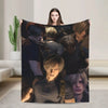 A graphic print featuring multiple portraits of characters in a dark, moody style on a throw blanket.