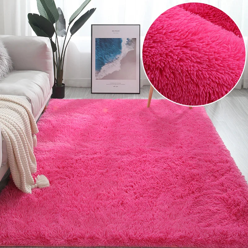A vibrant pink plush area rug with a fluffy texture displayed in a bright room setting.