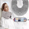 A woman rests her head on a gray cloth-filled U-shaped travel neck pillow in a white setting.