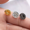 Three metal pin findings including a gold butterfly brooch clasp and two silver tie tacks are shown on a finger.