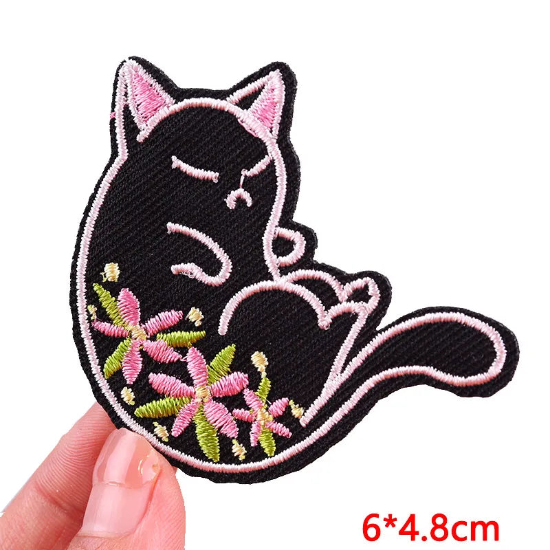 Black embroidered cat patch with pink floral accents