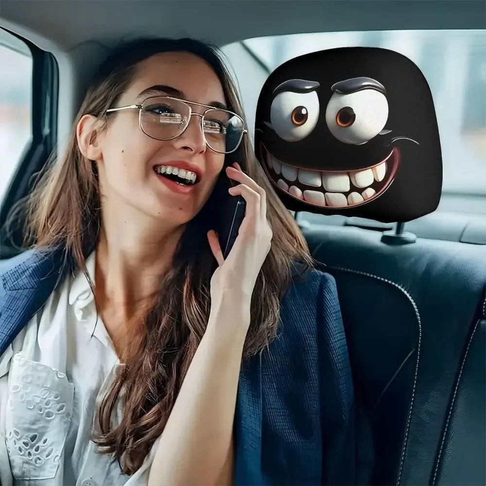 A woman smiling while holding a phone in a car interior, next to a decorative smiley face pillow cover.