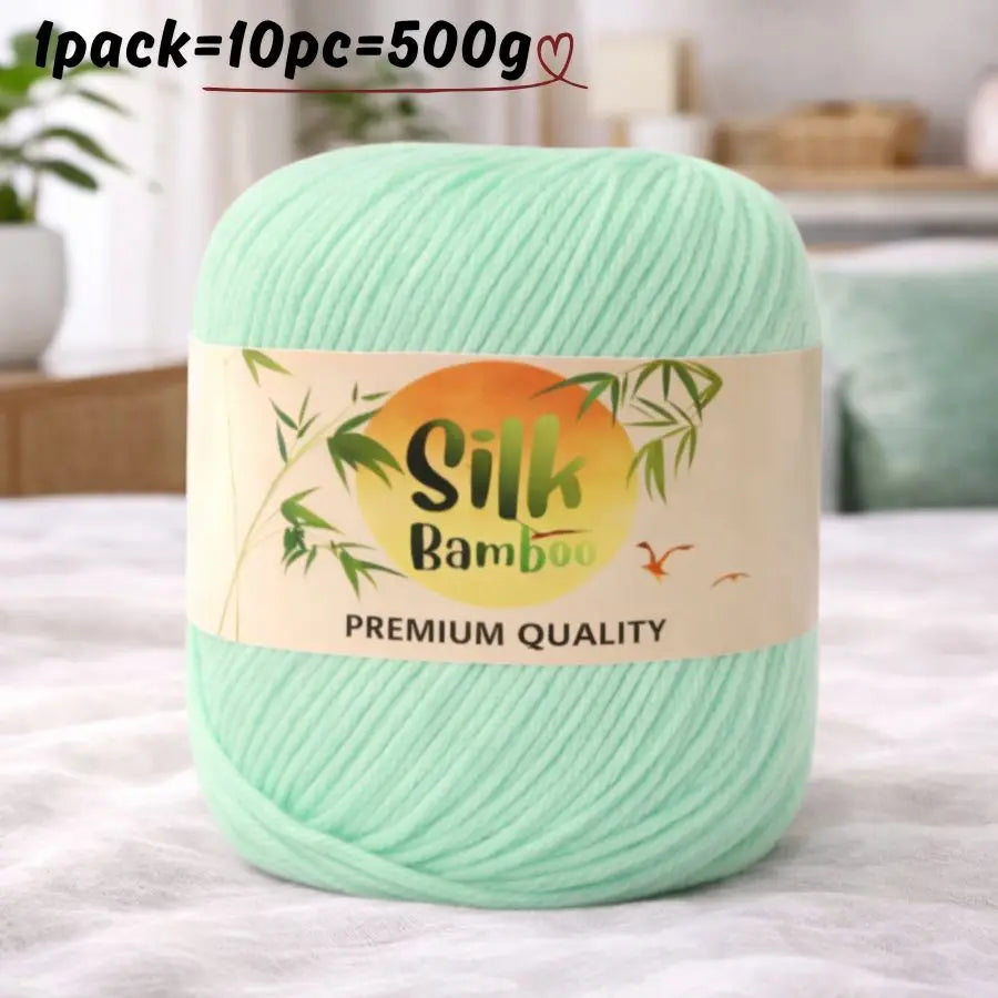 A ball of light green silk bamboo blend yarn labeled premium quality for knitting and crochet.