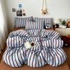 A set of soft washed cotton stripe duvet cover and pillowcases in blue and white stripes.