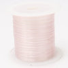 A roll of pink multicolor elastic beading cord.