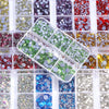 A grid of mixed size hotfix glass rhinestones in various colors and shades for crafts and apparel.