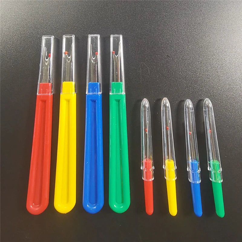 A set of colorful seam ripper and thread cutter tools in various colors including red, yellow, blue, green, and clear.