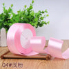 Roll of pink satin ribbon for gift wrapping and DIY crafts
