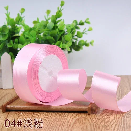 Roll of pink satin ribbon for gift wrapping and DIY crafts