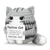 A handmade plush cat toy with gray and white fur texture sitting on a white background.