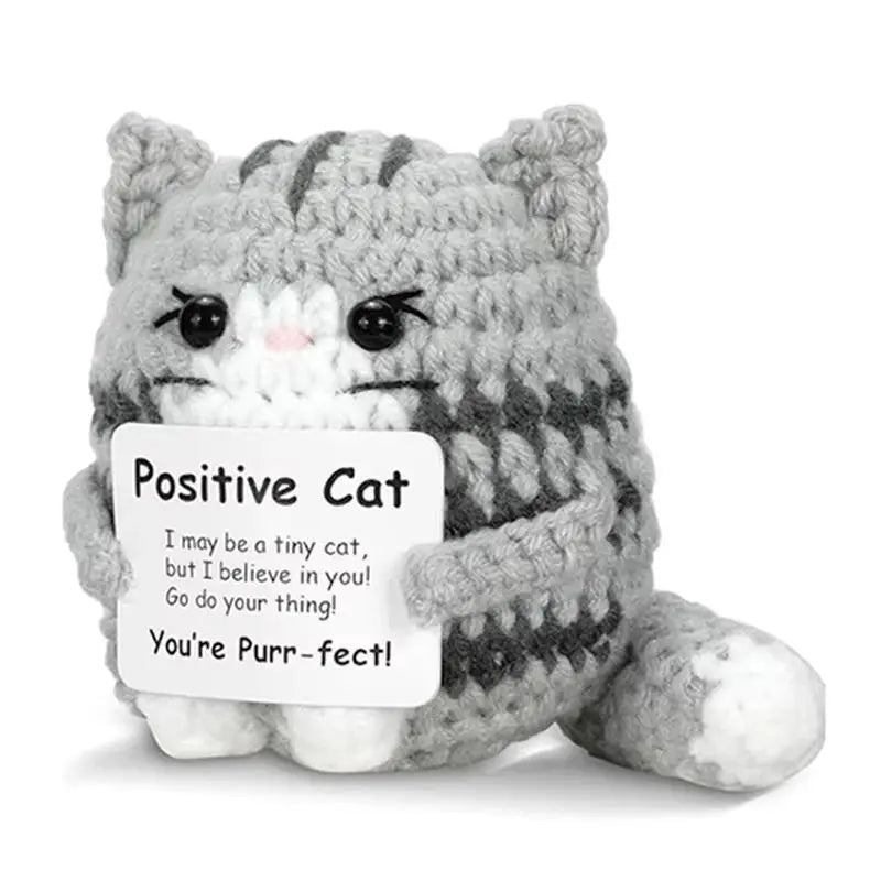 A handmade plush cat toy with gray and white fur texture sitting on a white background.