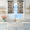 A set of two light-filtering printed wooden slat curtains hanging in a window above a farmhouse sink and countertop.