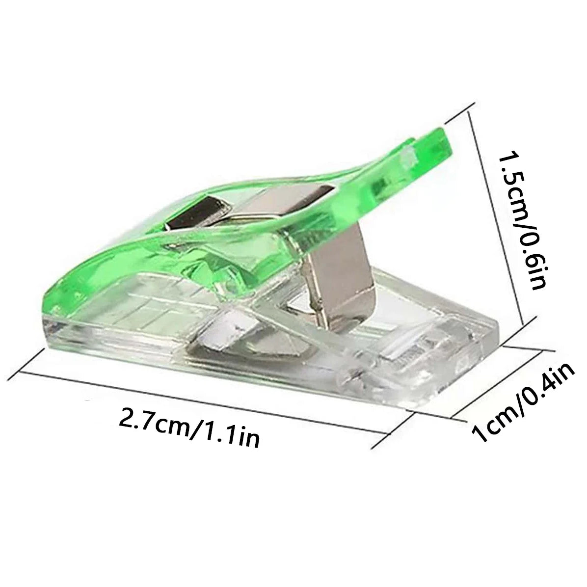 A clear plastic sewing clip with a green handle and silver clamp, shown from the side.
