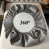 A gray waterproof quilted mattress protector is displayed on a white surface.