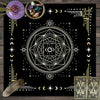 A dark mat featuring a geometric tarot design, celestial symbols, and small bowls with crystals.
