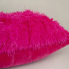 A vibrant magenta faux fur throw pillow cover with a fluffy texture.