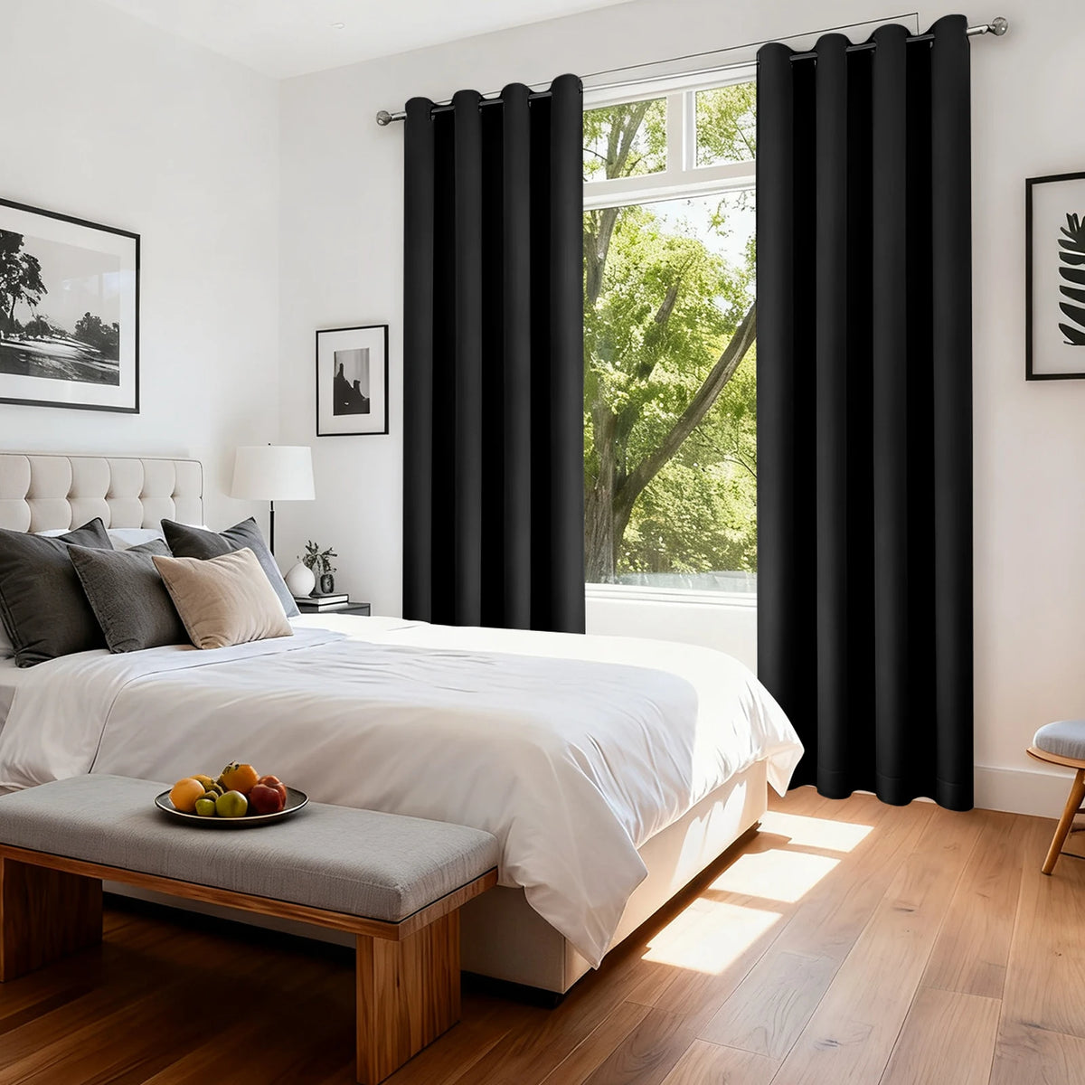 A black thermal curtain is drawn on a window in a bright bedroom setting.