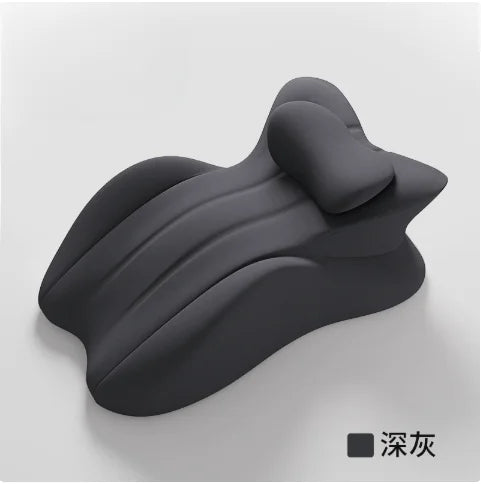 A dark gray memory foam wedge pillow with a contoured, wavy shape.