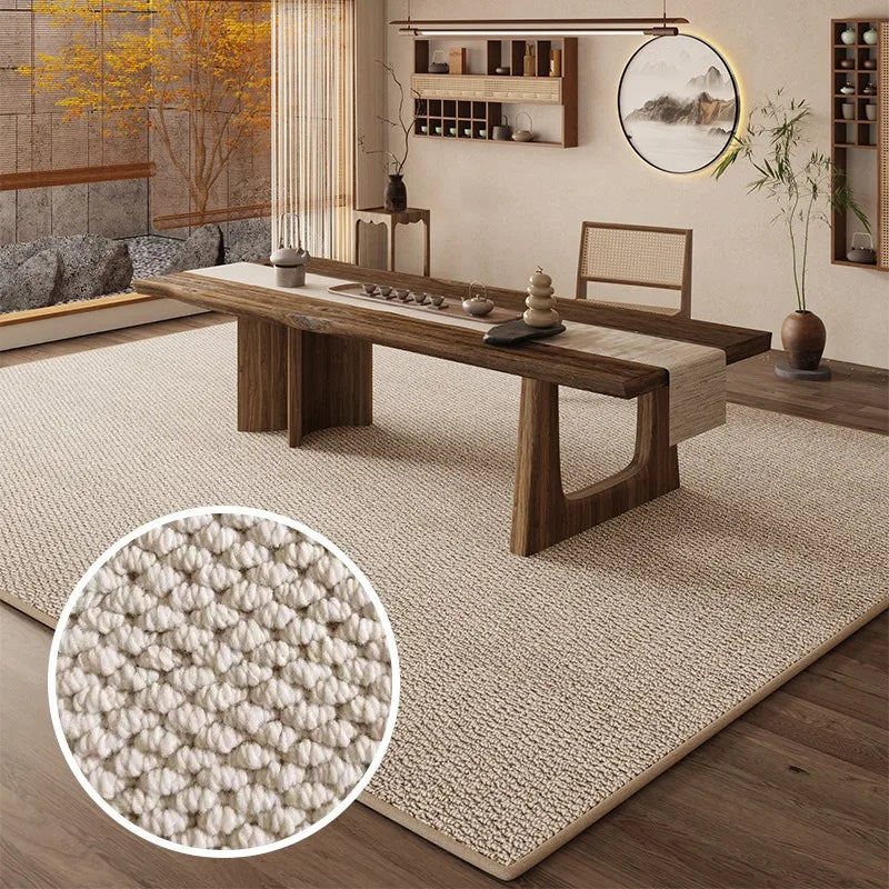 A woven faux sisal runner rug placed on a wooden table in a bright interior setting.