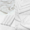White flannel blanket folded and draped, showing soft texture and print details.