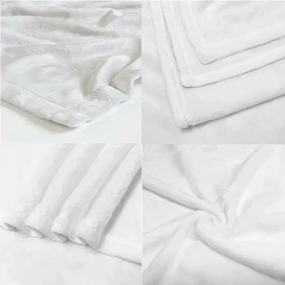White flannel blanket folded and draped, showing soft texture and print details.
