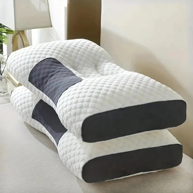 A stack of white and dark gray quilted massage neck pillows for ergonomic support.