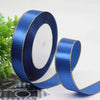 Roll of royal blue satin ribbon with a gold edge for gift wrapping and crafts