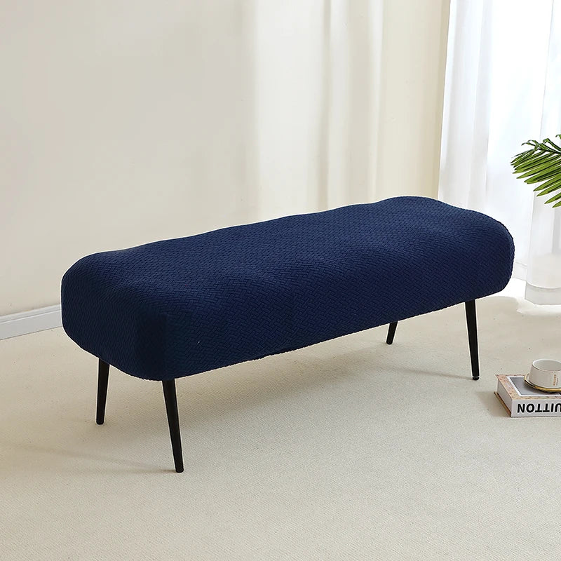 A navy blue elastic jacquard bench cover used as protection for a piano, dining, or entryway seat.