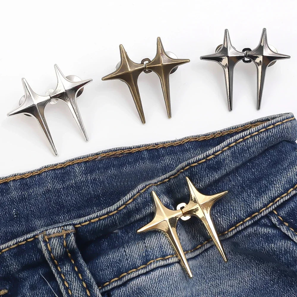 Gold-toned Y2K star clips for jeans and skirts displayed against a dark denim background.