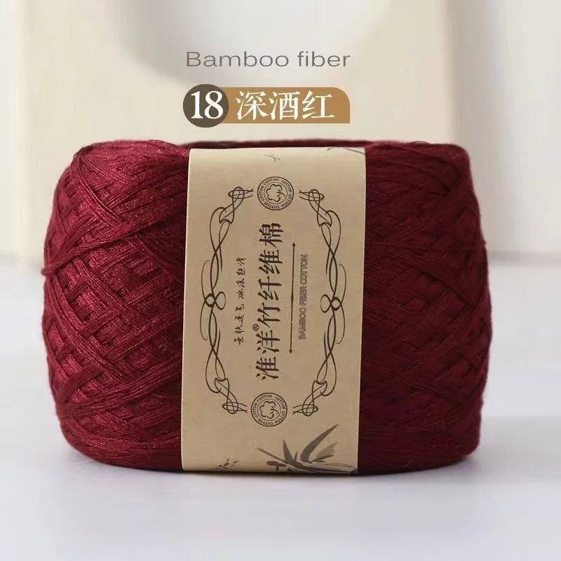 A ball of deep red bamboo fiber yarn used for crafting.