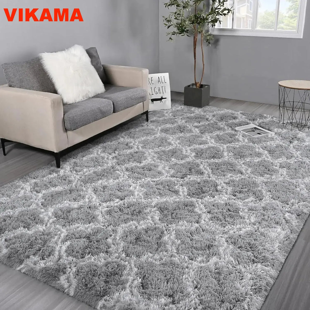 A fluffy gray geometric plush area rug placed on a wooden floor in a modern living room setting.