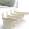 White invisible bed sheet fixing clips shown in a close-up view