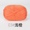 A ball of bright orange organic cotton 4ply knitting yarn for crafts.
