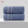 Two stacked blue microfiber face towels with white stripes.