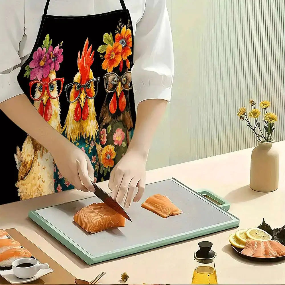 A person wearing a black apron with a funny chicken and floral print is preparing salmon on a cutting board.