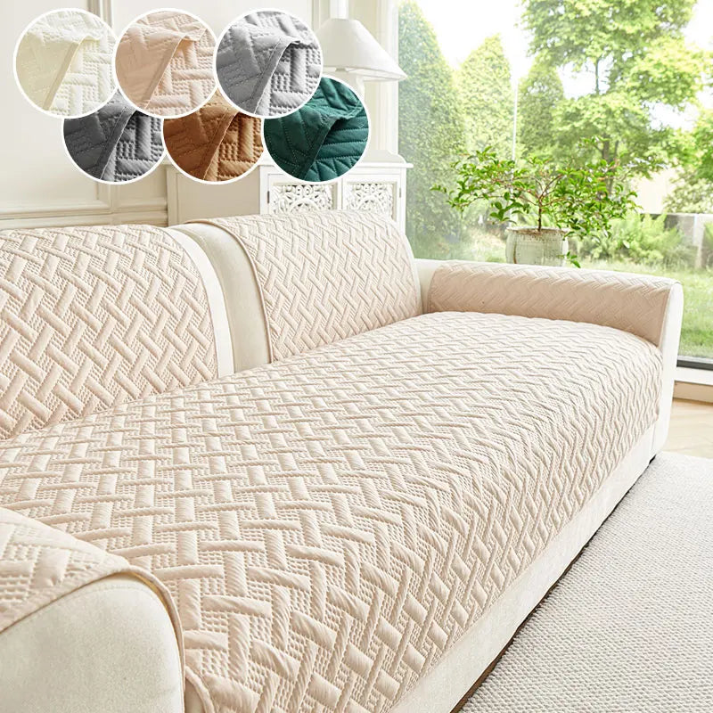 A beige quilted sofa cushion with a diamond pattern displayed on a light-colored sofa.