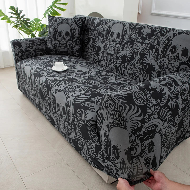 A stretchable festive sofa cover with a black and gray skull pattern displayed on a sofa.