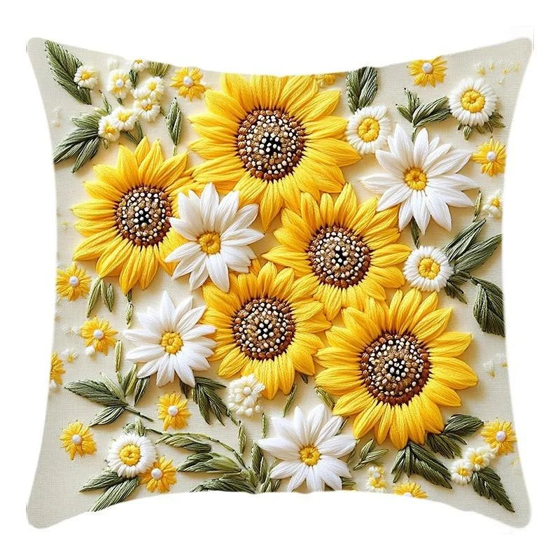 A decorative cushion pillow cover featuring a floral pattern of yellow and white sunflowers and greenery.