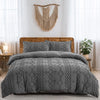 A gray boho tufted microfiber duvet cover set displayed on a wooden bed with sheer white curtains.