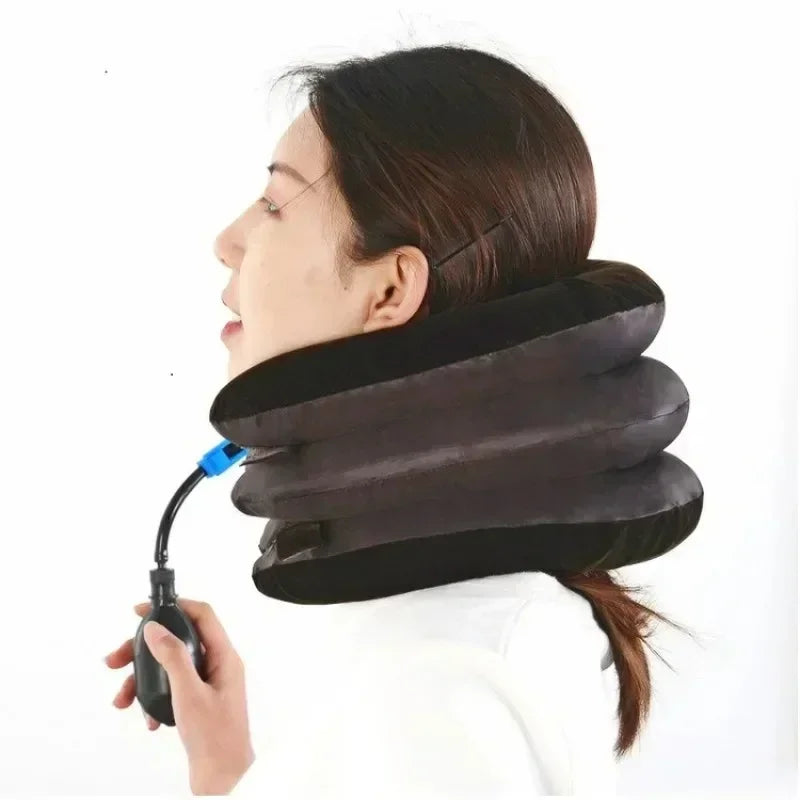 A person is using an inflatable cervical traction neck stretcher pillow for a stretch or therapy.