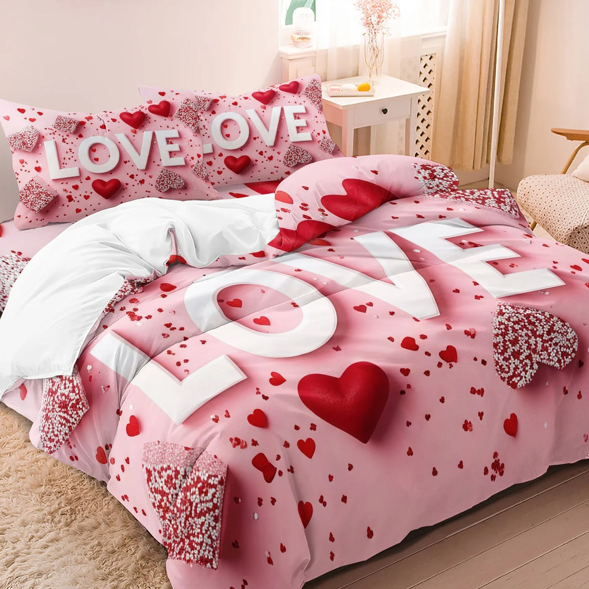 Pink bedding set with red hearts and floral patterns featuring the words LOVE and OVE