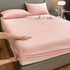 A pink luxury velvet bedding set featuring a sheet and pillow, displayed on a bed.