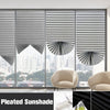 A close-up view of pleated blackout curtains covering a large window, showing various folds and light filtering through.