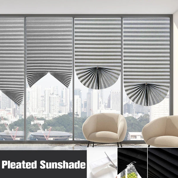 A close-up view of pleated blackout curtains covering a large window, showing various folds and light filtering through.